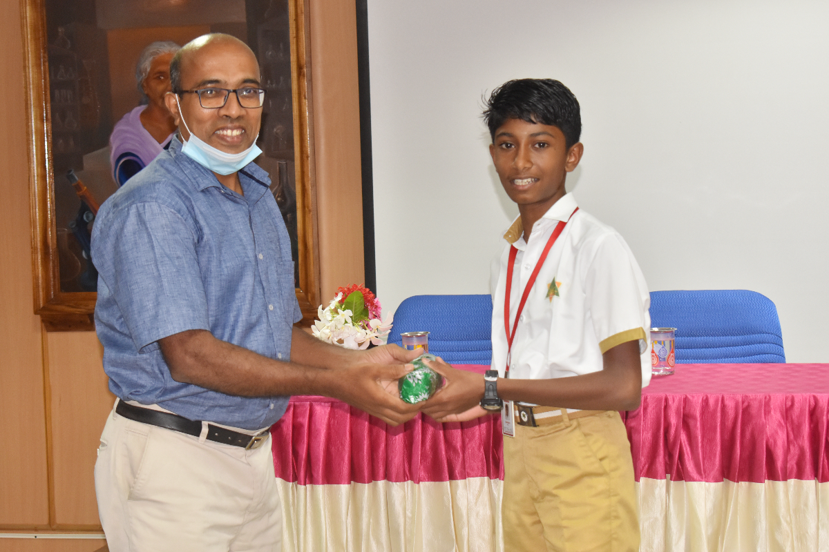 Winner from Jaycee School receiving the Consolation prize from Dr. R. Manikandan.